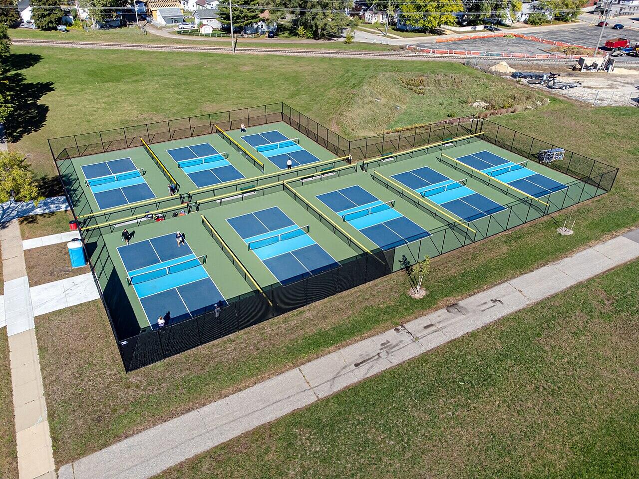 Aerial view of a row of pickleball courts
