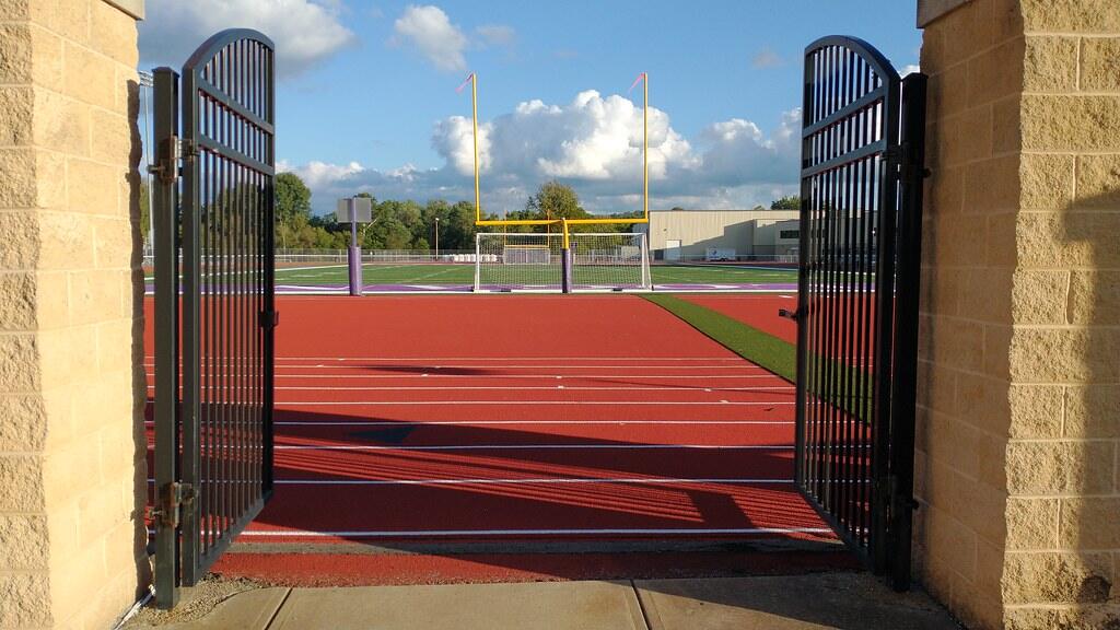 Gate opening onto a running track